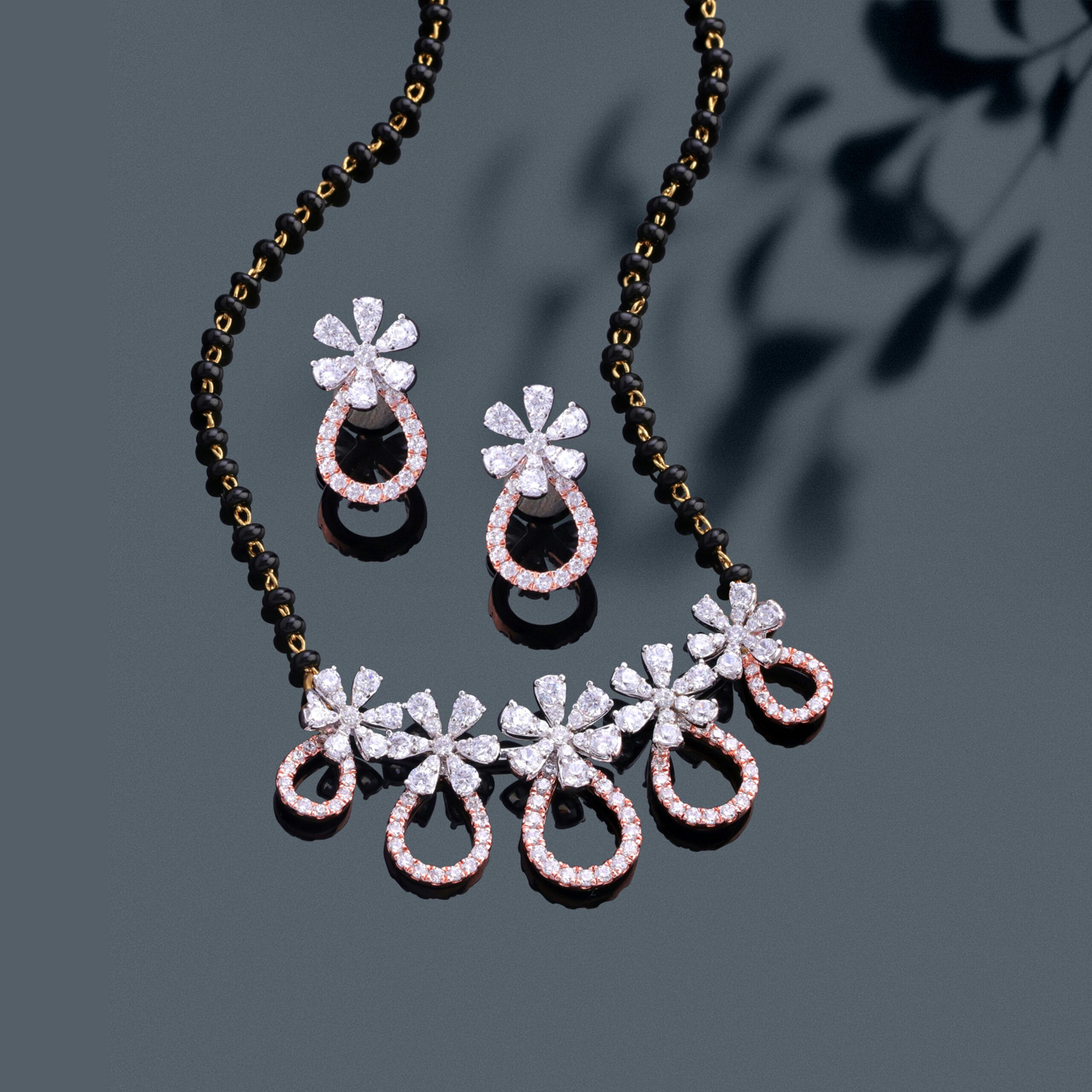 Luxury Qazi jewellers diamond necklace and earrings set elegantly displayed on a dark surface, showcasing opulence and craftsmanship.